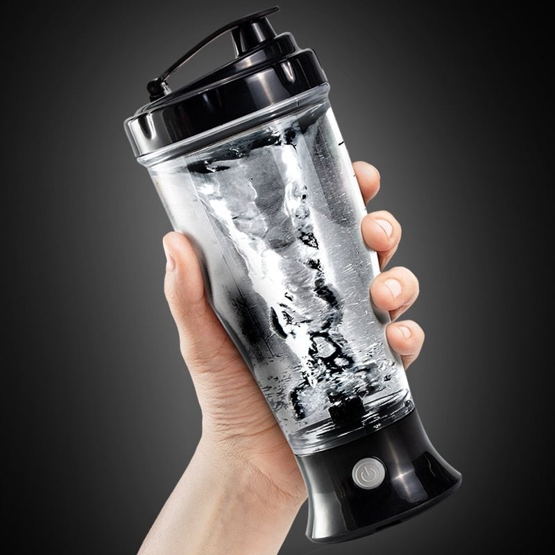 a person holding a blender in their hand