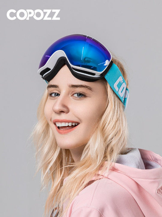 a woman wearing ski goggles and a pink hoodie