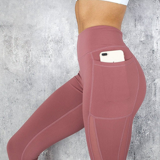 a woman in pink leggings with a cell phone in her pocket