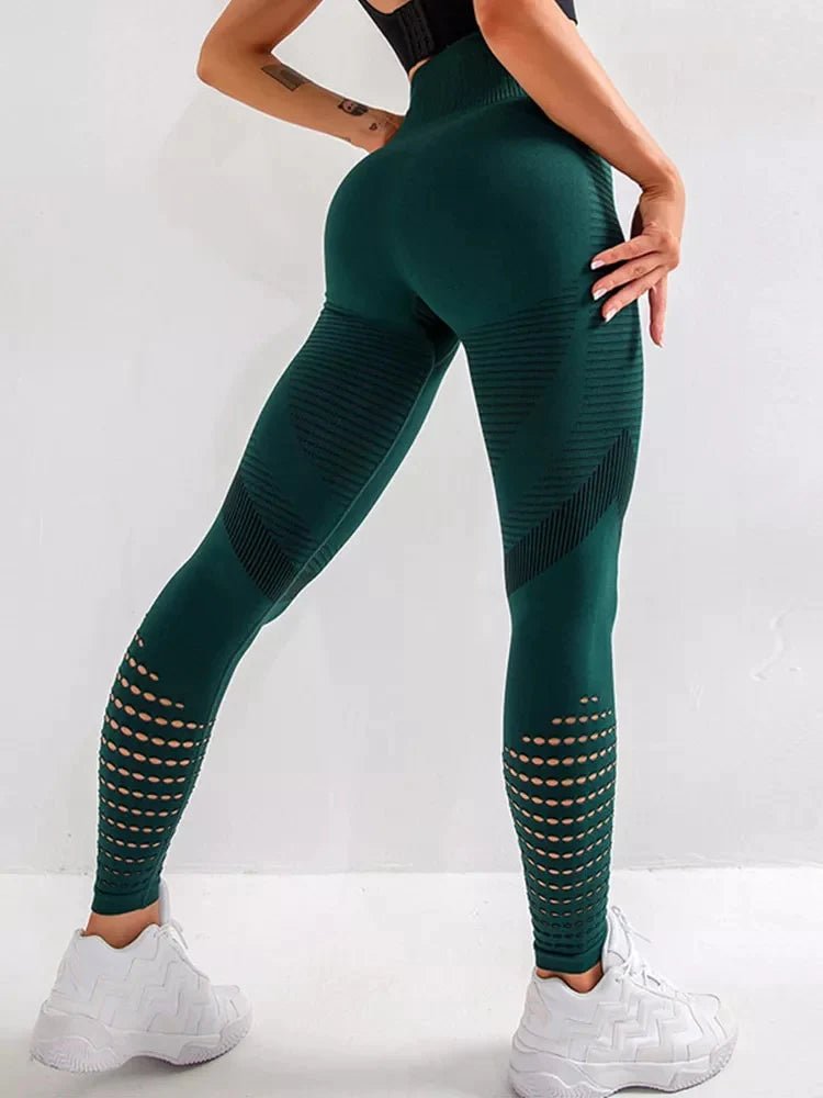 a woman in a black top and green leggings