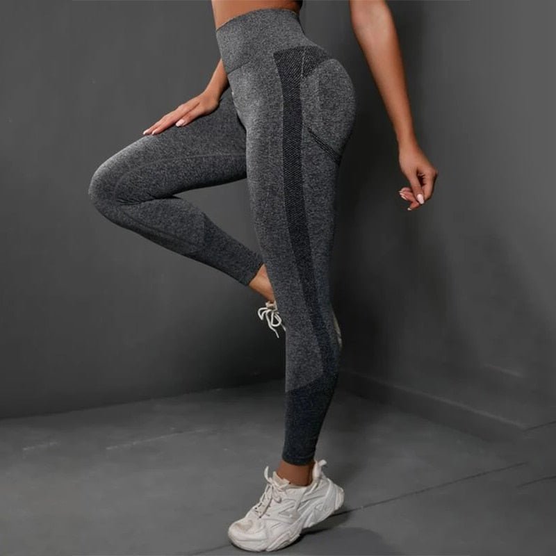 a woman in grey and black leggings posing for a picture