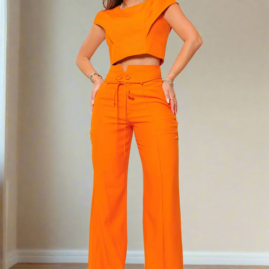 a woman in an orange outfit posing for a picture