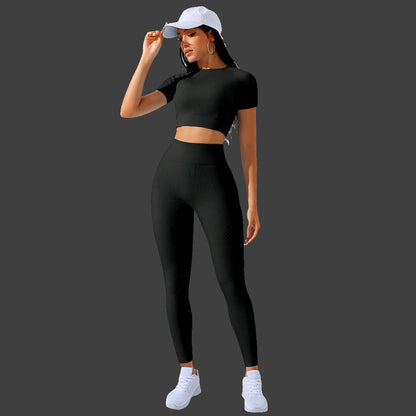 a woman wearing a black crop top and leggings