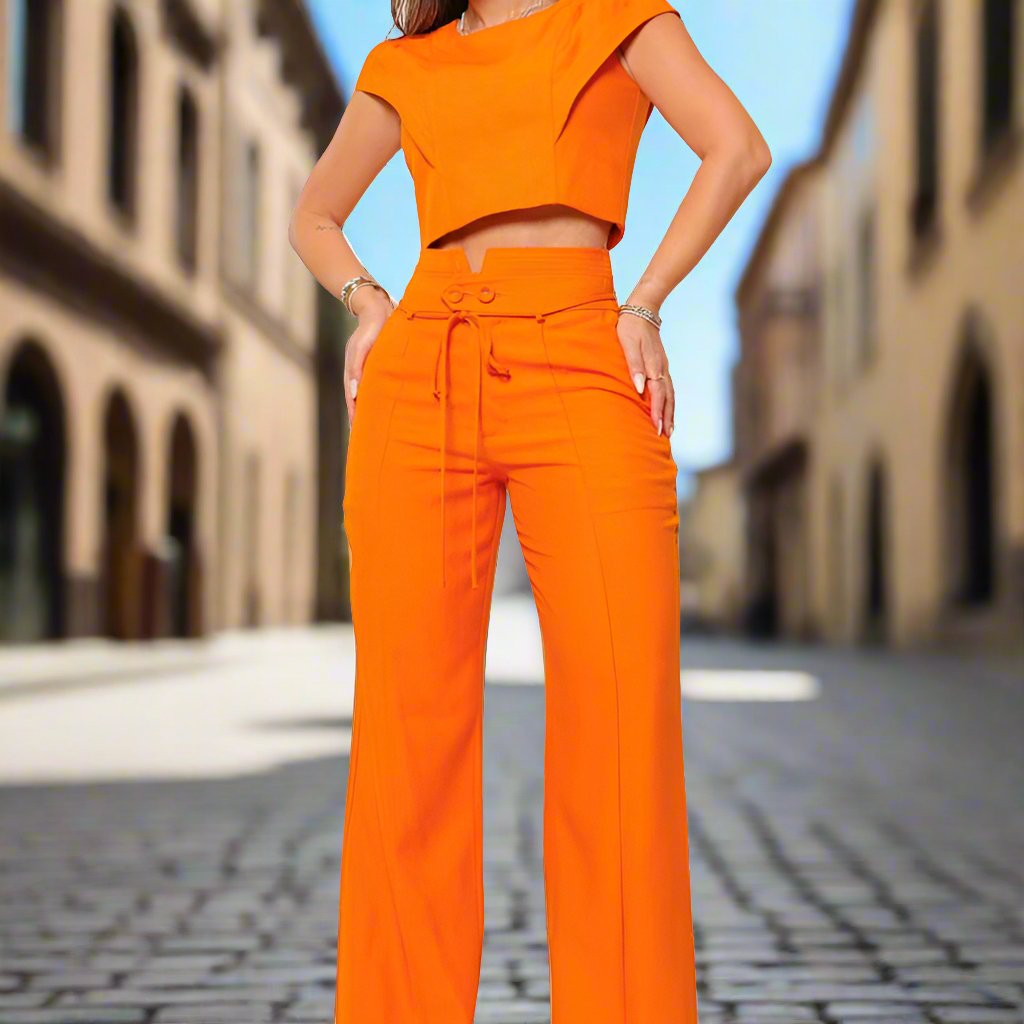 a woman in an orange outfit posing for a picture