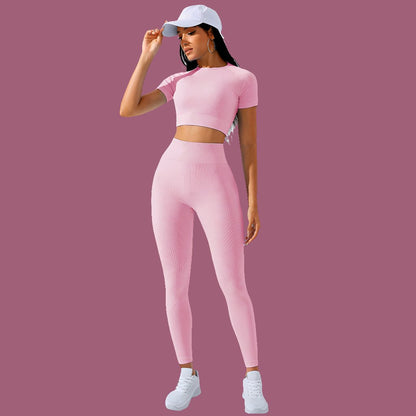 a woman in a pink sports outfit poses for a picture